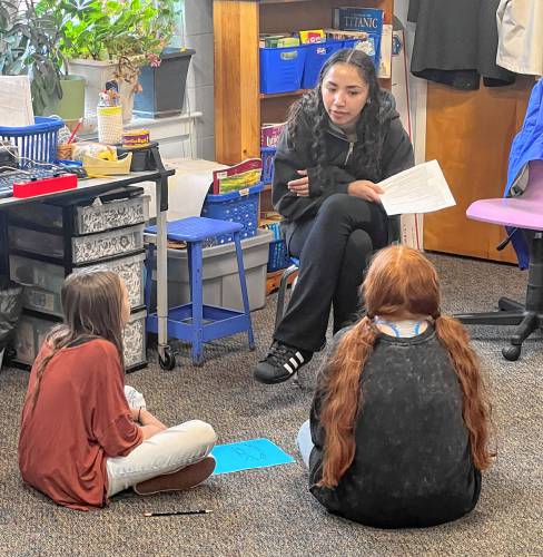 FPU student Isabell Collier works with Rindge Memorial School children on stories during the Writing Nest club.