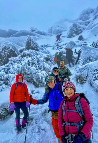 From front, Judy Rubin of Alstead, Scott Whitehill of Brattleboro, Vt., Alexis Joyce of Palmer, Mass., Peter Travisano of Phillipston, Mass., and Claudia Burdett-Lerner of Spofford descend the White Arrow Trail after a full day on Mount Monadnock Jan. 3