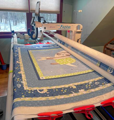 A custom quilt project in the longarm machine at The Quilted Bug. 