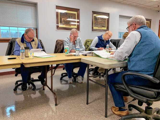 Town Manager Jon Frederick presents the Select Board's proposed budget to Budget Committee members Charlie Turcotte, Chair Norman Langevin and Bob Schaumann during a Budget Committee meeting on Saturday.