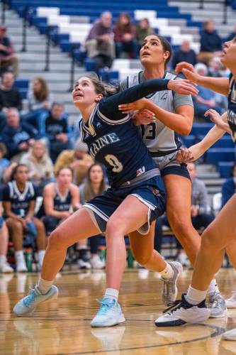 Junior Sera Hodgson of the University of Maine women’s basketball team boxes out University of New Hampshire junior Clara Gomez during the Black Bears’ 78-52 win over the Wildcats in Durham on  Jan. 11.