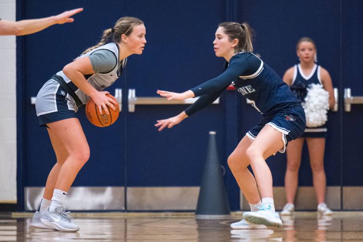 Sera Hodgson defends UNH guard Maggie Cavanaugh during the UMaine/UNH women’s basketball game. 