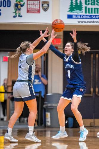 Sera Hodgson guards UNH’s Maggie Cavanaugh during the UMaine/UNH women’s basketball game. 