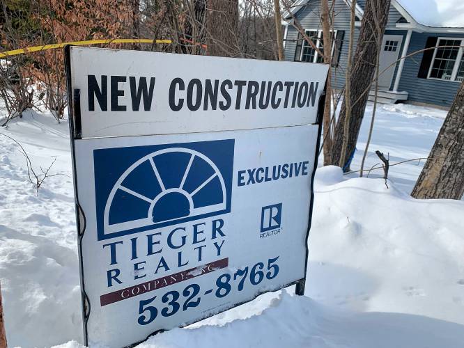 A for sale sign on Highland Avenue in Jaffrey advertises a newly constructed home.