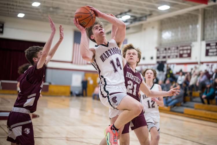 Wilton-Lyndeborough junior Ben Jacob goes to the basket as Derryfield defends during the Cougars' 61-33 win over the Warriors in Wilton Monday.